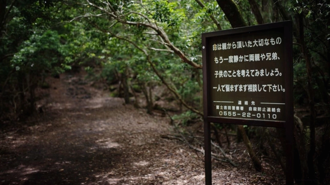 A sign at the entrance of the Aokigahara forest urges suicidal visitors to reach out for help.